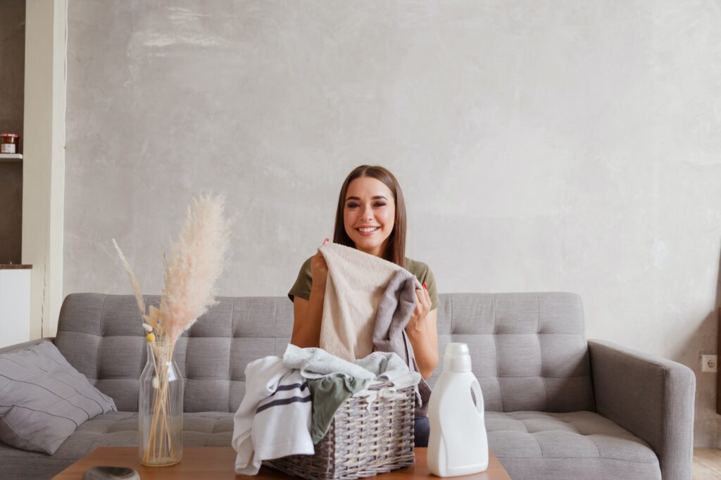 Customer holding freshly cleaned laundry after using special care laundry service in Frederick MD