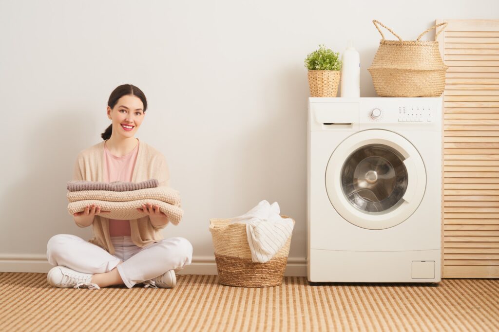 Woman organizing laundry at a wash and fold laundromat in Frederick MD