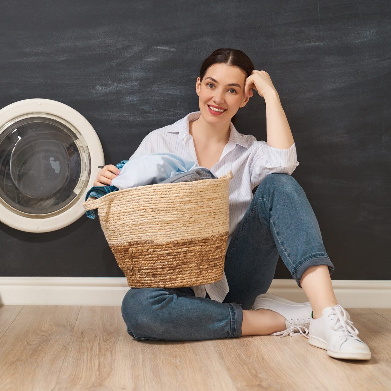 Woman sorting clothes at an affordable laundromat in Frederick MD with budget-friendly laundry services
