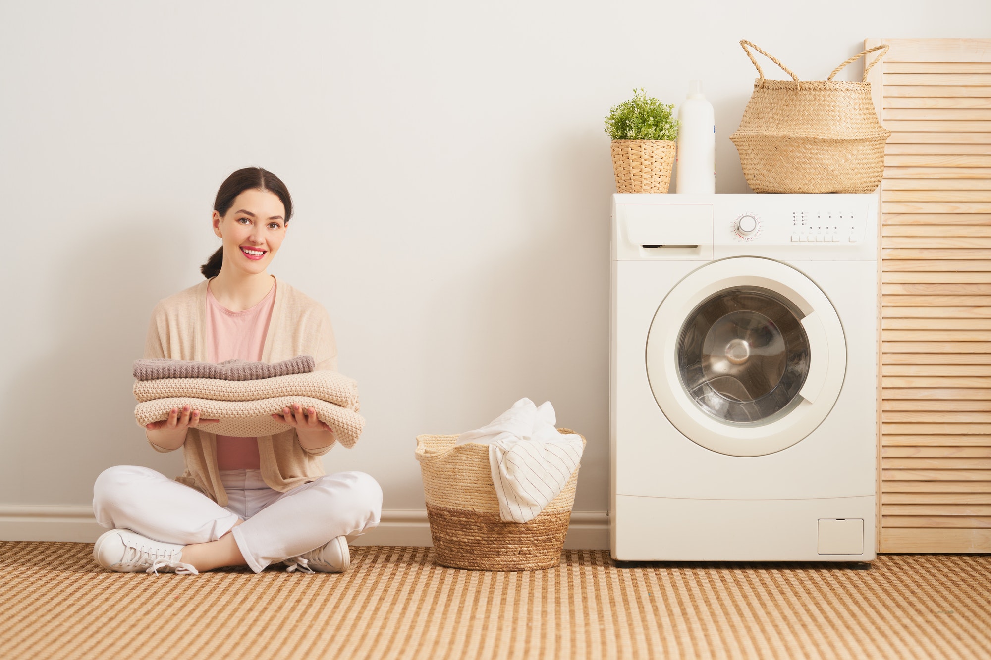 Woman organizing laundry at a wash and fold laundromat in Frederick MD
