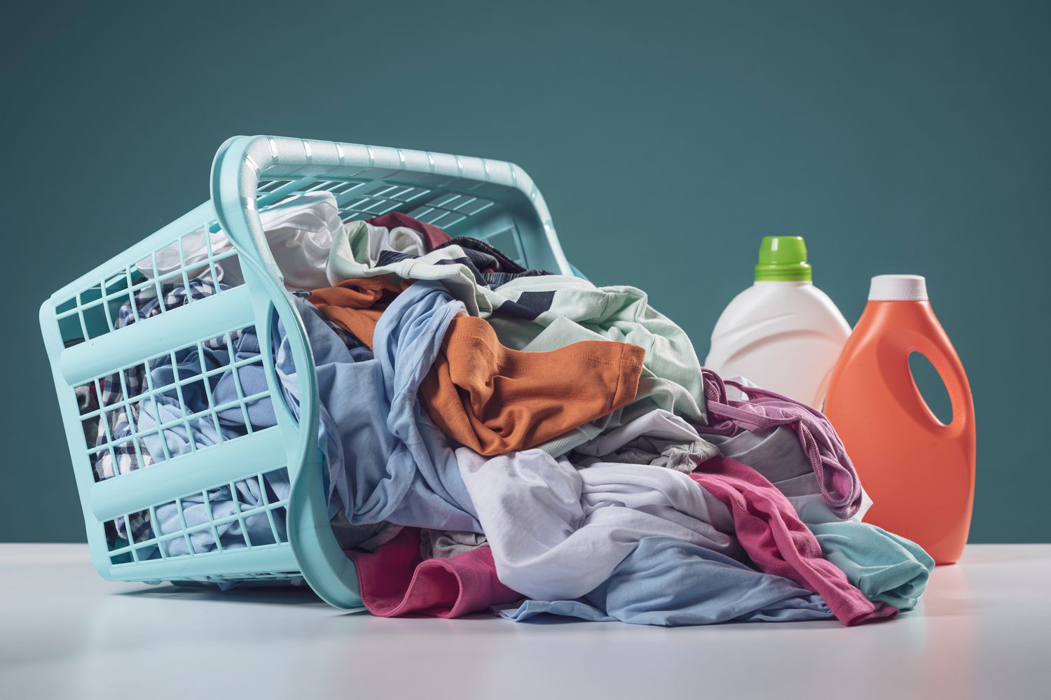 Commercial laundry services for Urbana businesses with a basket of laundry and detergent representing professional cleaning solutions
