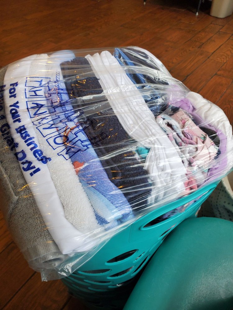 Freshly washed and folded laundry prepared for pickup at 4th Street Laundromat in Frederick MD