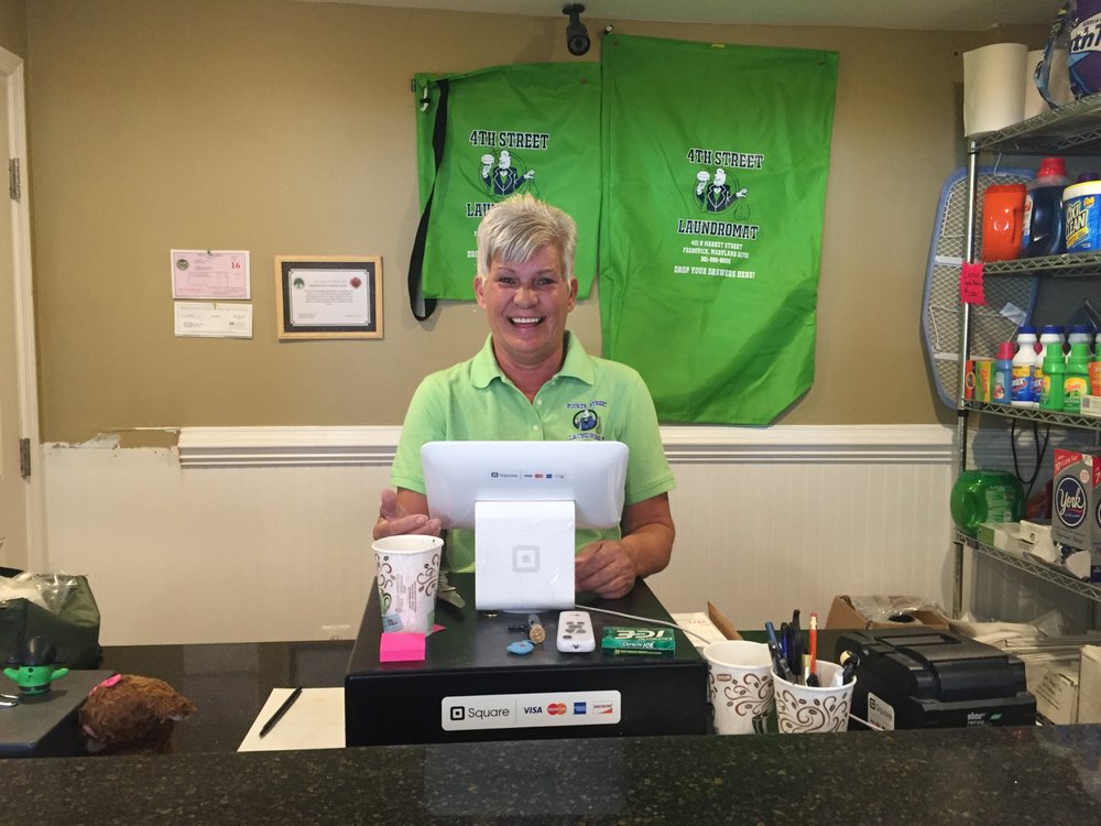 Friendly staff assisting customers with special care laundry services in Frederick MD