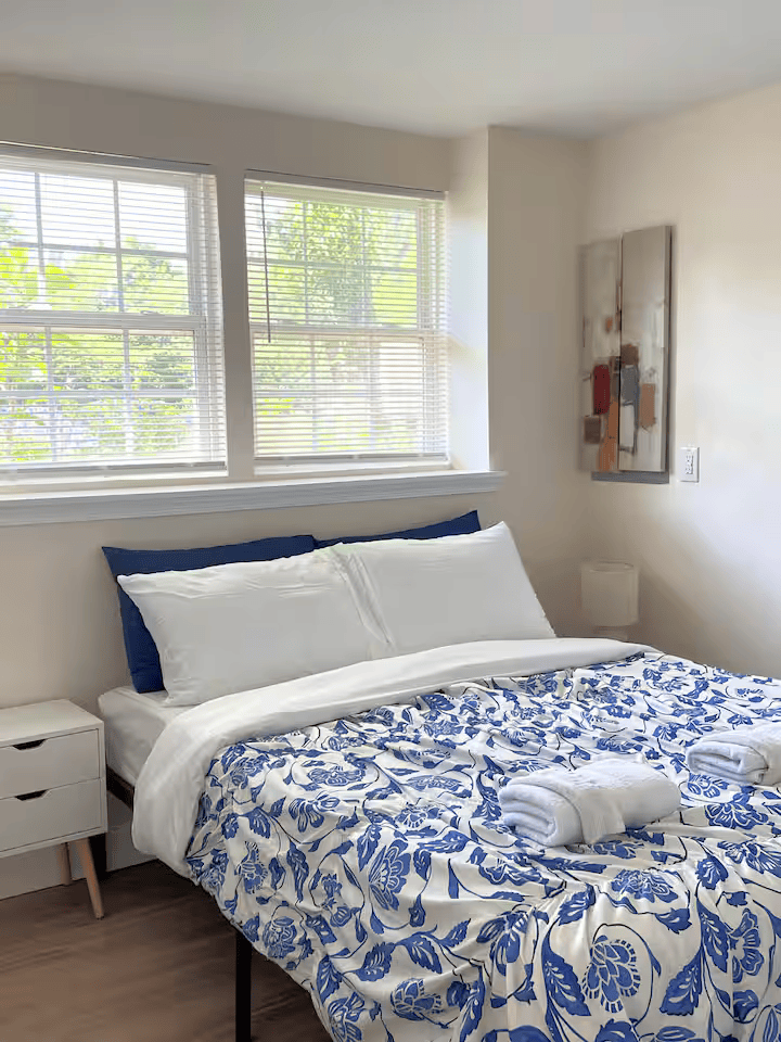 Cozy vacation rental bedroom with neatly made blue and white bedspread in Frederick MD