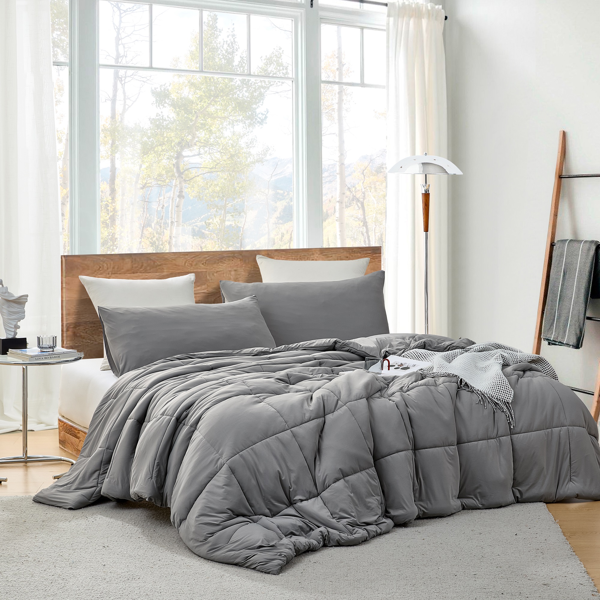 Cozy bedroom with a gray comforter requiring special care laundry service